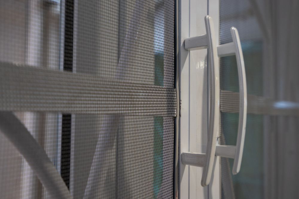 A Close Up of a White Handle on a Screen Door — Whitsunday Architectural Windows & Doors in Proserpine, QLD
