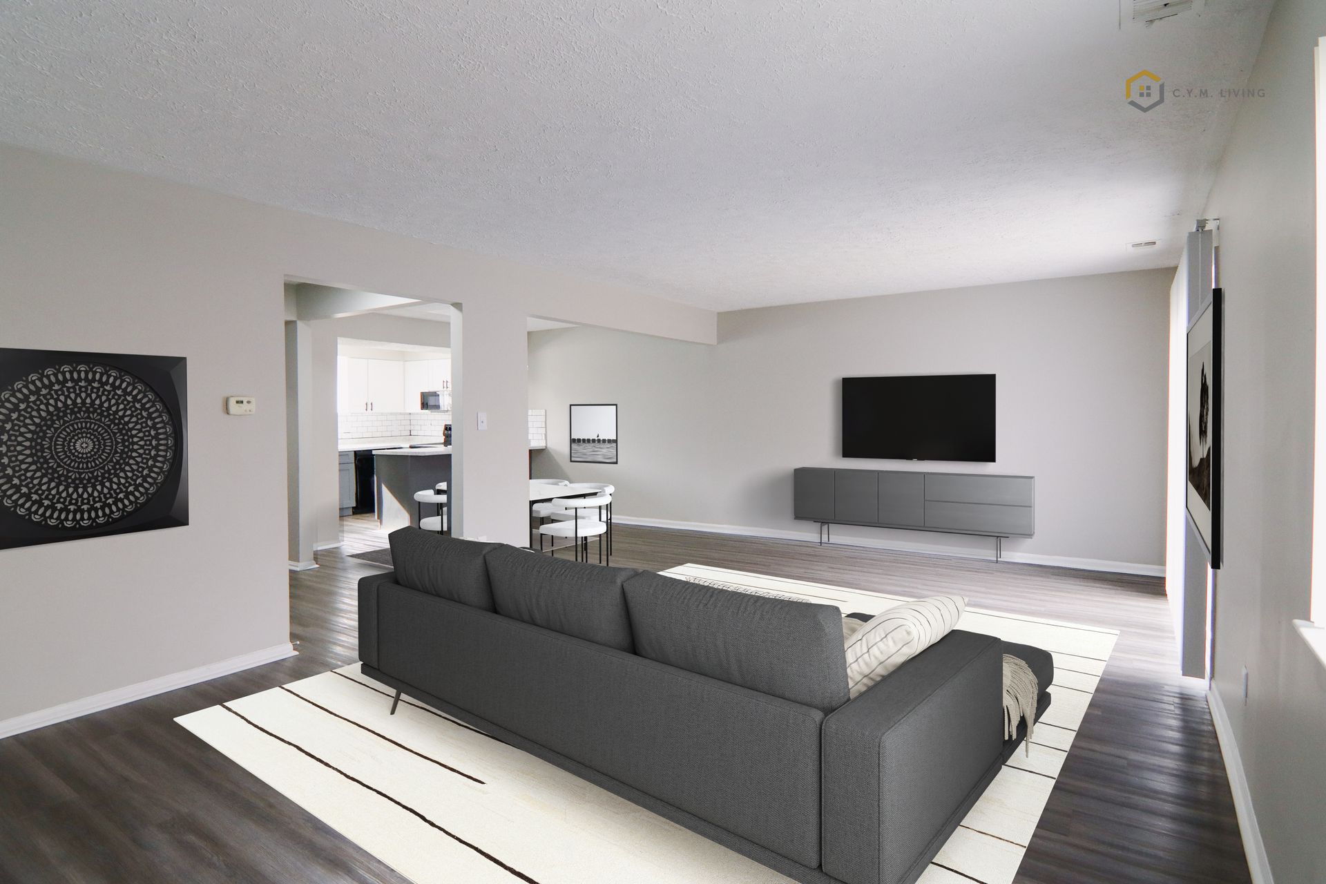 Gray living room with sofa, TV, and dining area visible in the background.