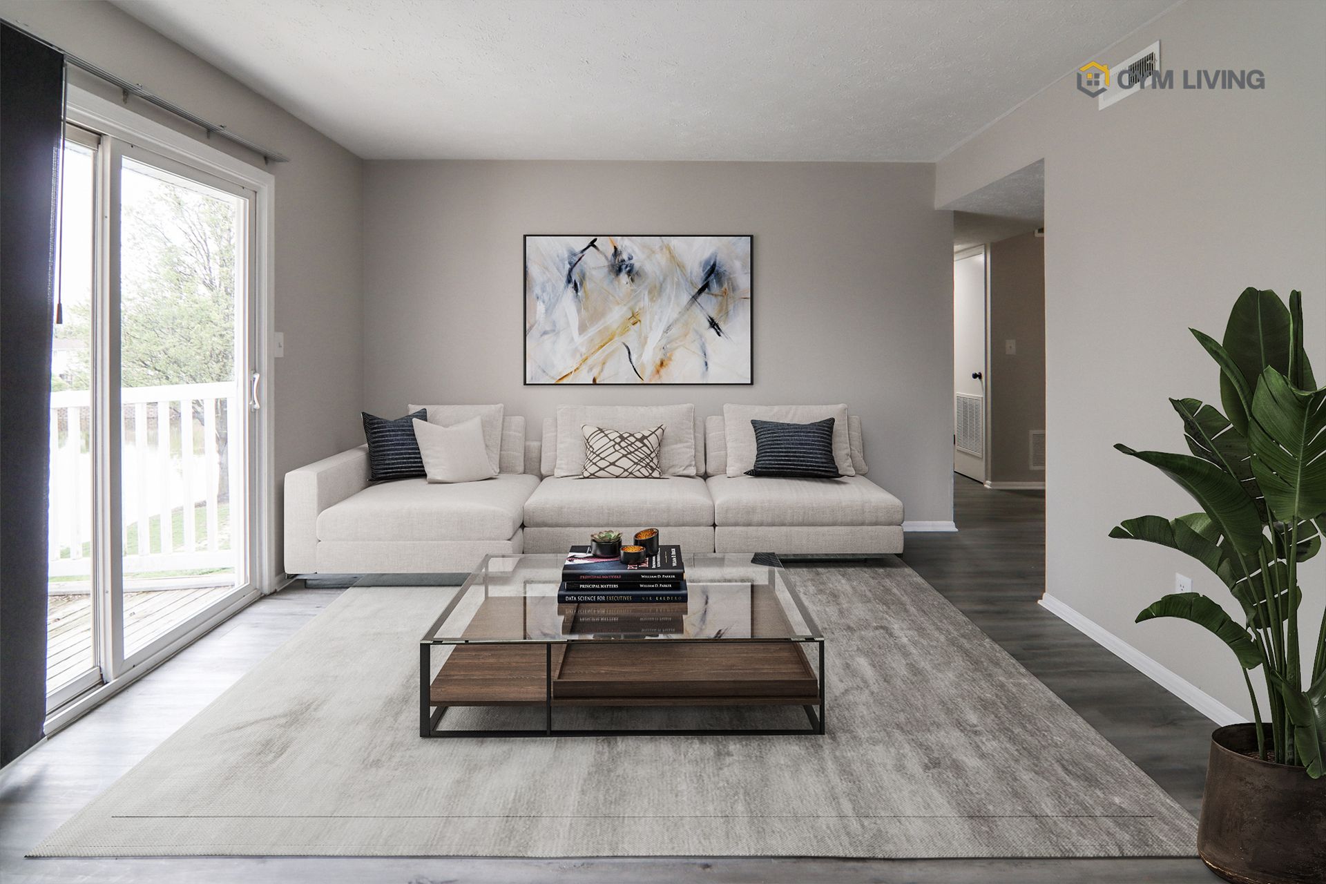 Living room with white sectional sofa, glass coffee table, and sliding door to a deck.