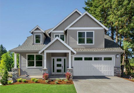 Gray two-story house with white trim, garage, front door, and windows on a sunny day.