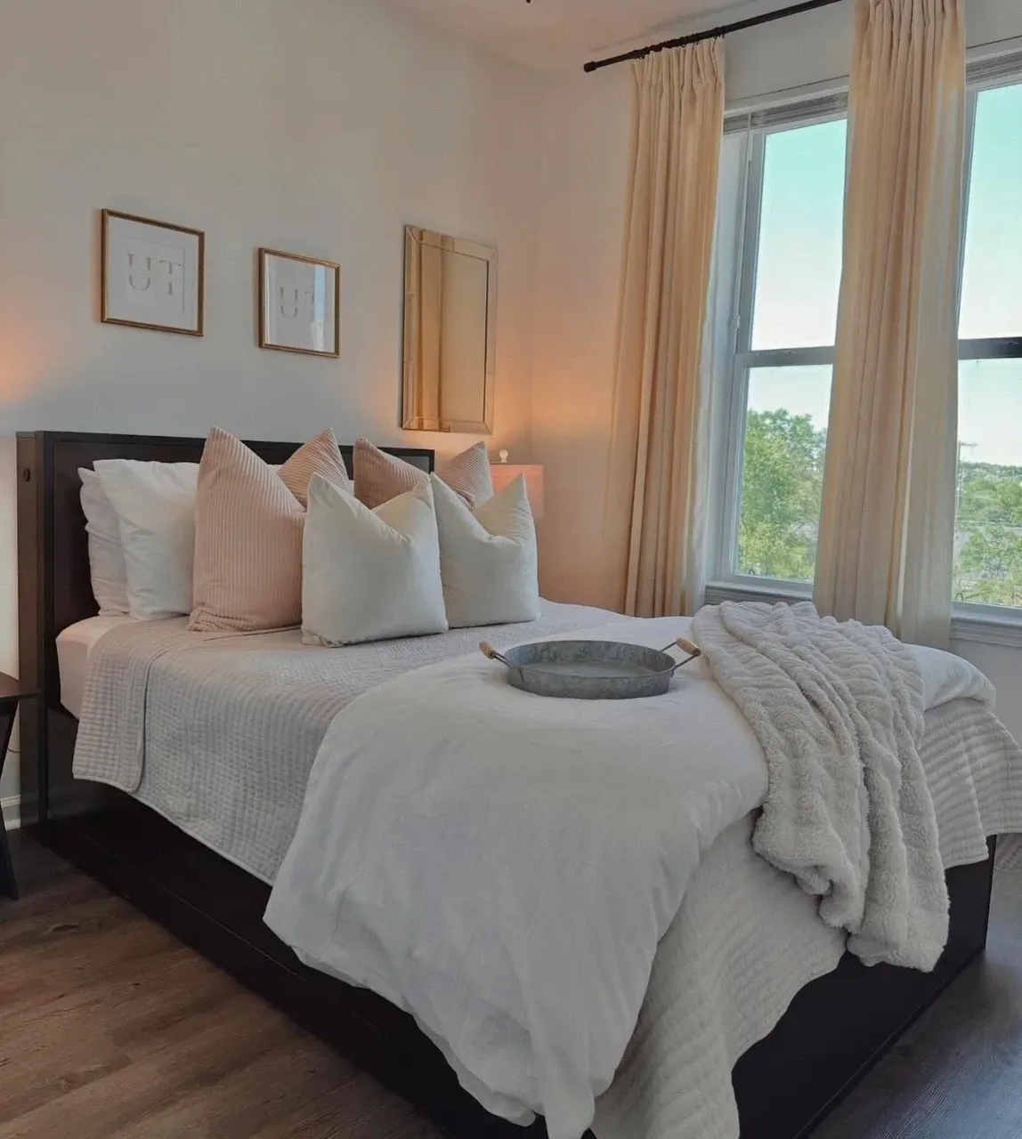 Cozy bedroom with a queen-size bed, plush pillows, and large windows.