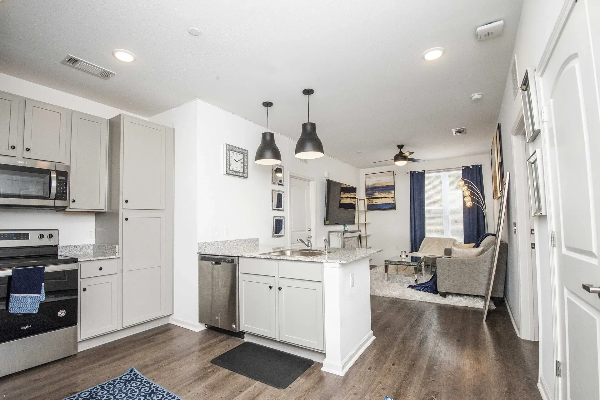 Modern kitchen and living area in an apartment.