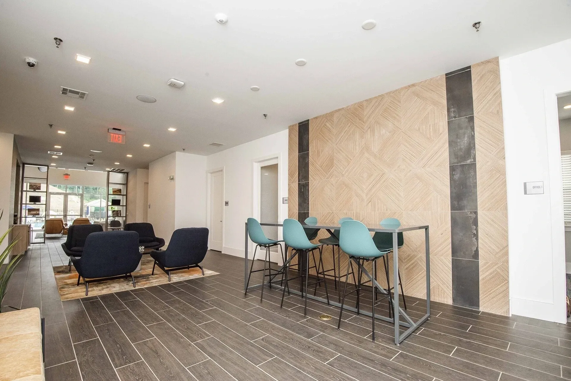 Lobby seating area with a high-top table and chairs and a lounge area with sofas.