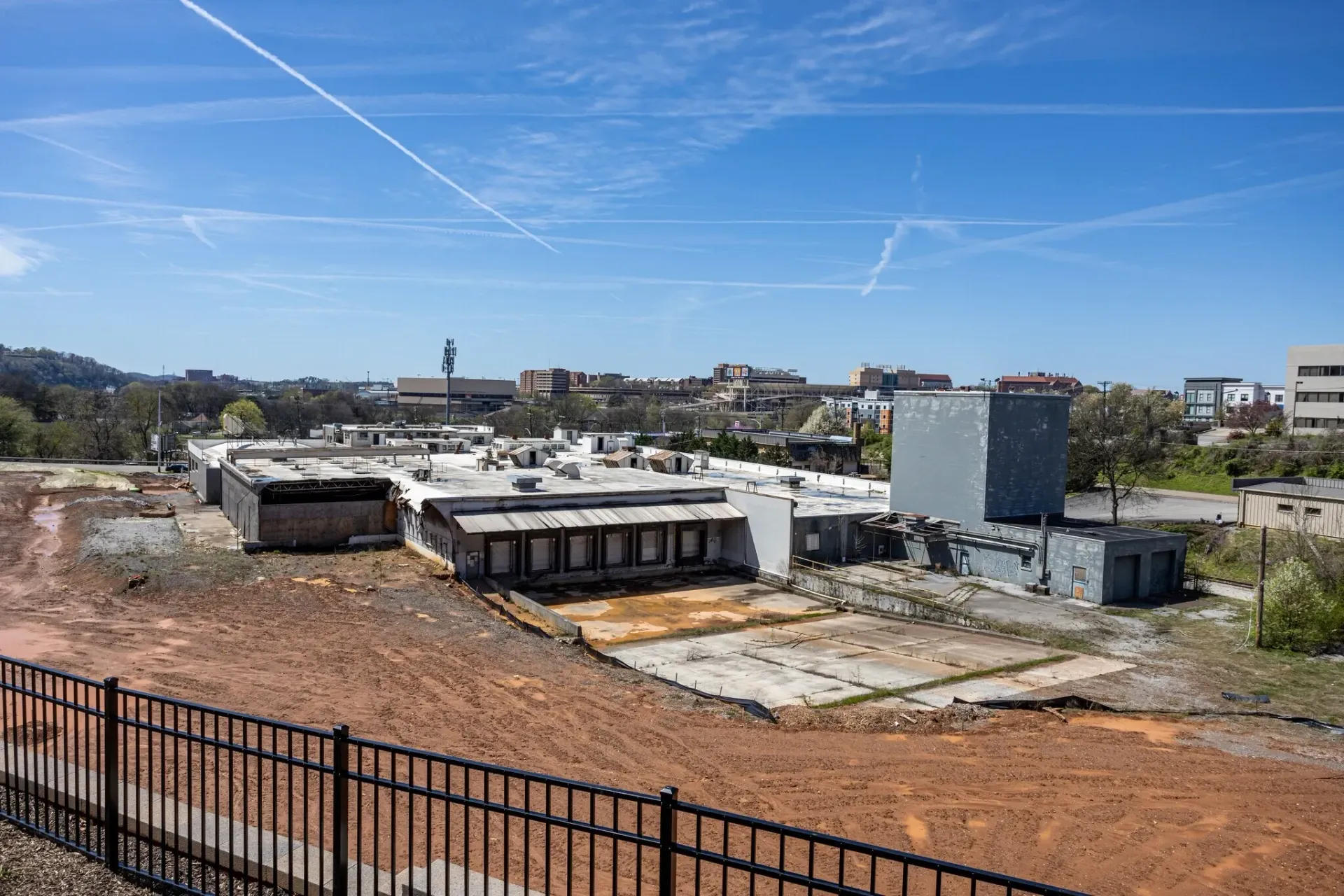 View of buildings under construction with a cityscape in the background.