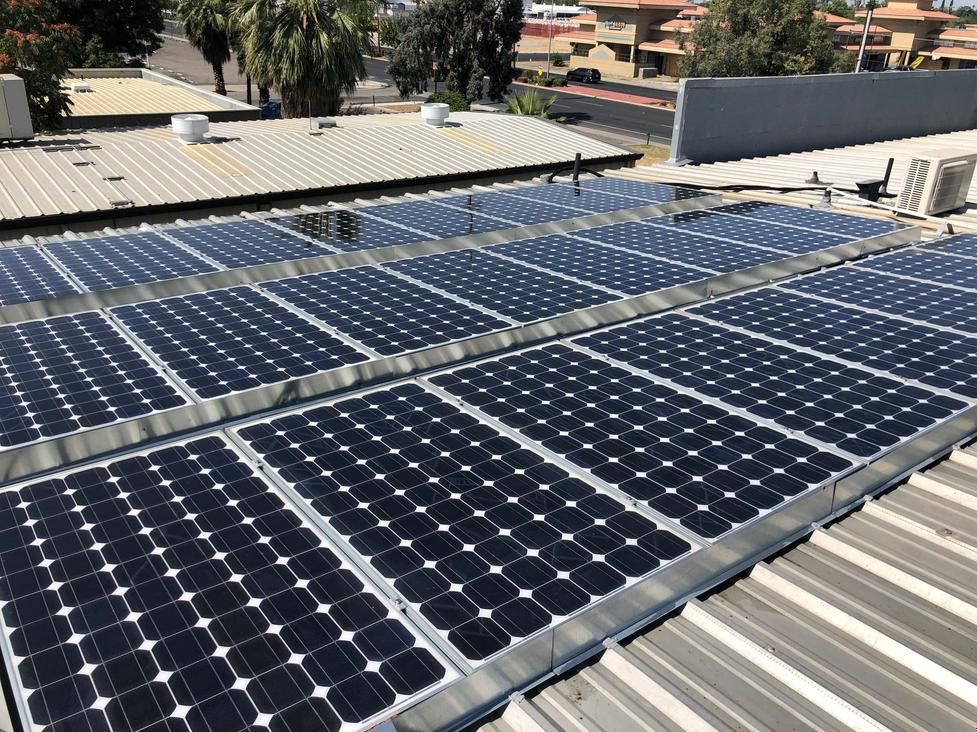Solar panels installed on a rooftop under daylight.