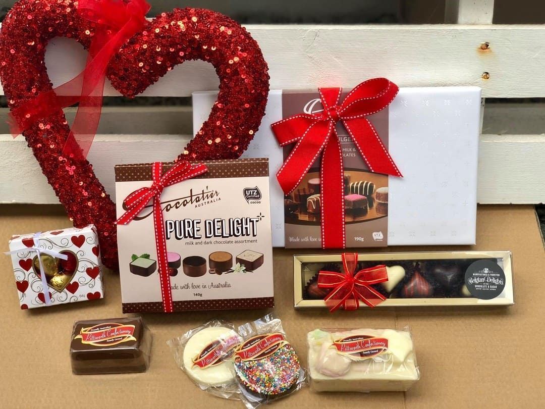 A Heart Shaped Wreath Is Sitting Next To A Box Of Chocolates — Clover Country Flowers and Gifts In Highfields, QLD