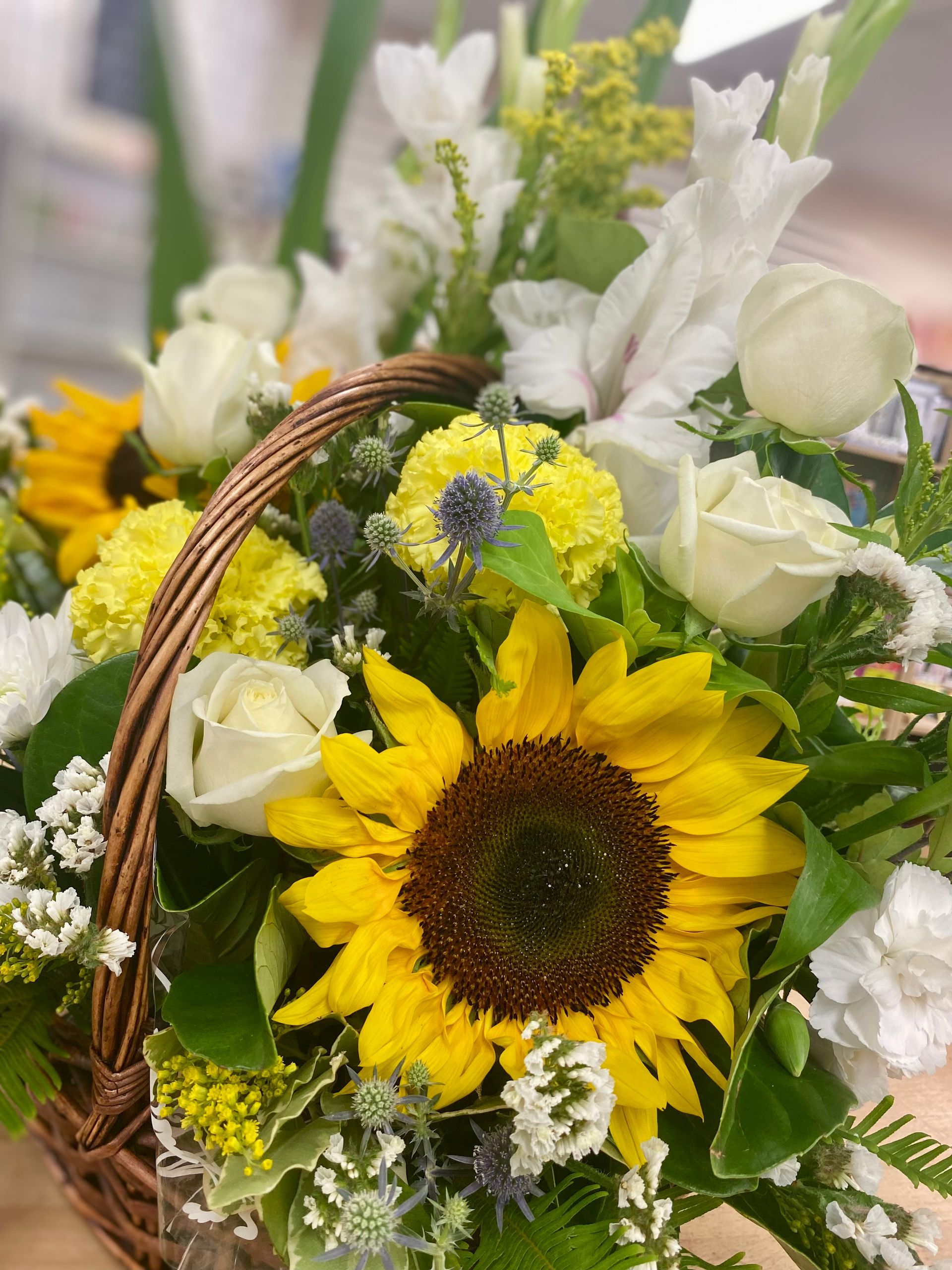 A Person Is Holding A Bouquet Of Flowers Wrapped In Purple Paper — Clover Country Flowers and Gifts In Pittsworth, QLD