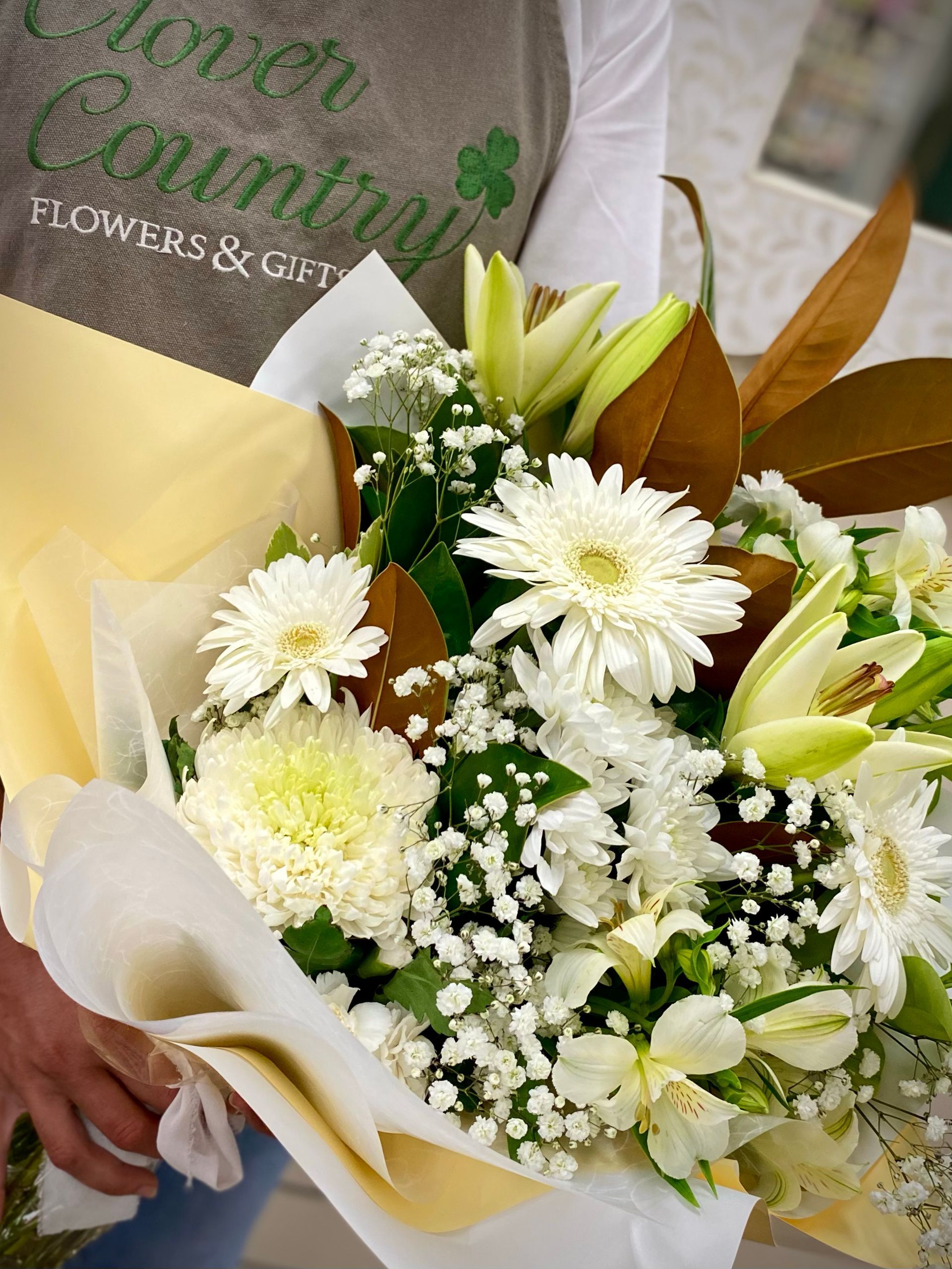 A Vase Filled With Flowers Is Sitting On The Ground — Clover Country Flowers and Gifts In Pittsworth, QLD