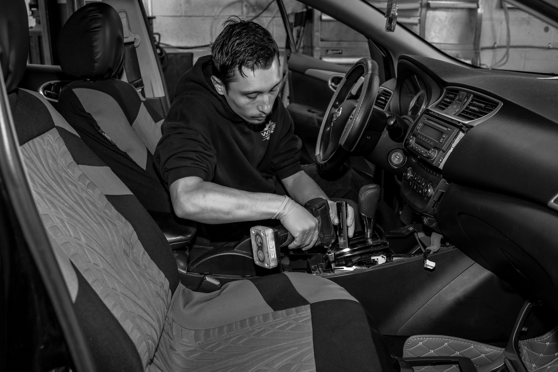 A man is working on the interior of a car.