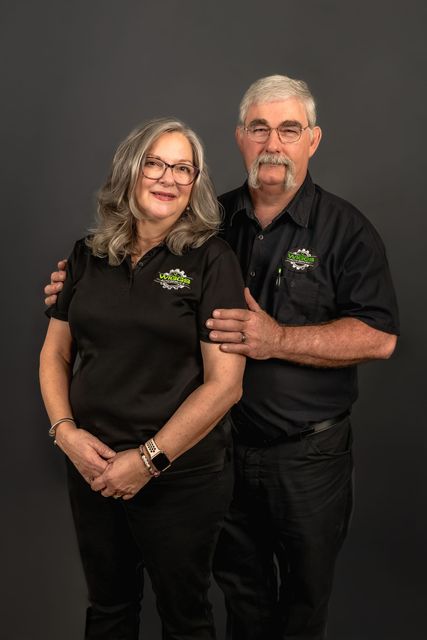 A man and a woman are posing for a picture together.