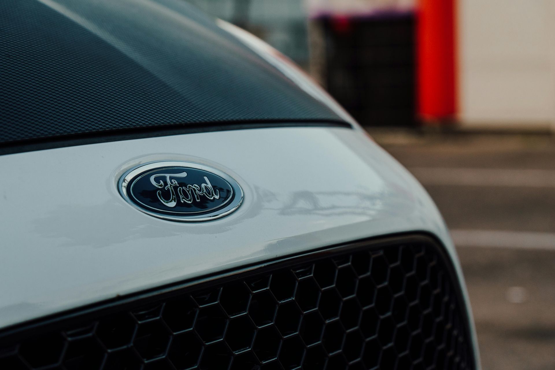 Close-up of a white Ford car front grille and emblem