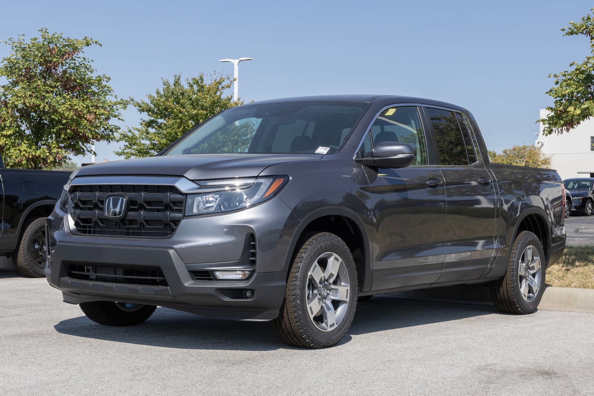 Gray Honda pickup truck parked outdoors on a sunny day