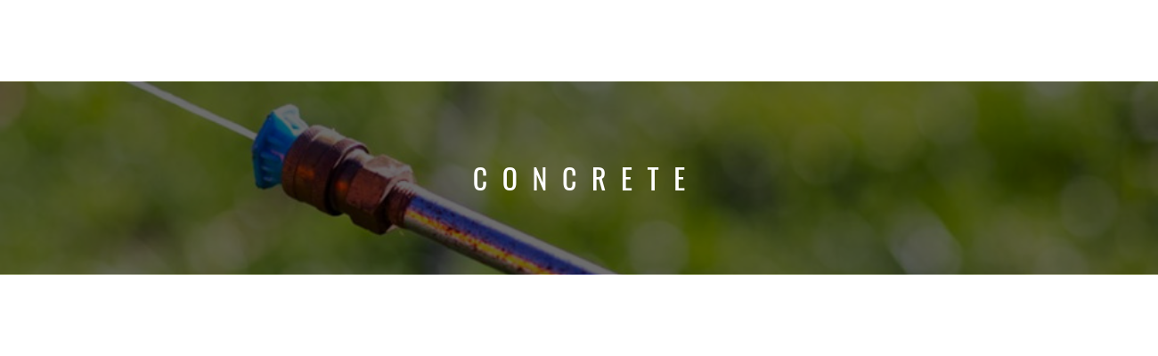 A metal spray nozzle is shown angled against a blurry green background, with the word 