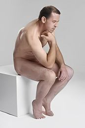 Professional male nude life model posing naked for a life drawing art class