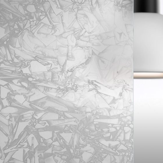 Primo piano di una lampada in vetro satinato con una texture simile al marmo bianco e una base argentata