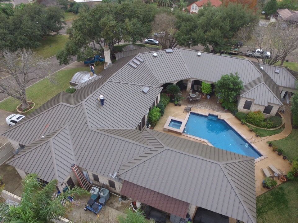 Residential roof with a pool in the backyard and newly installed metal roof.
