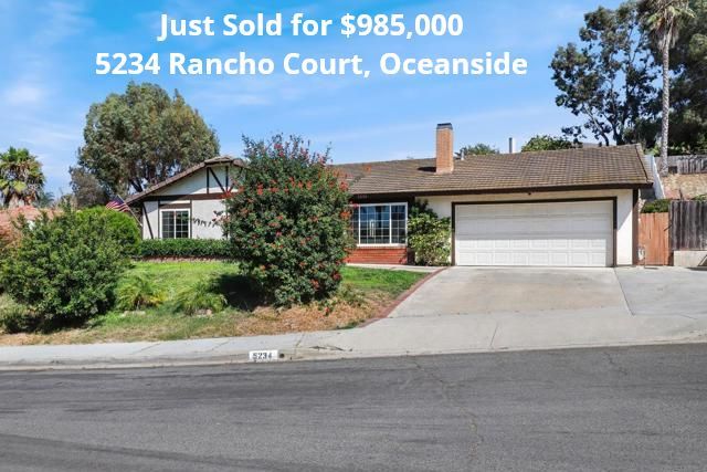 Sold real estate sign over a suburban house with two-car garage on Rancho Court, Oceanside
