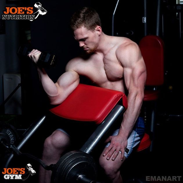 Man Working Out With Dumbbell In Gym