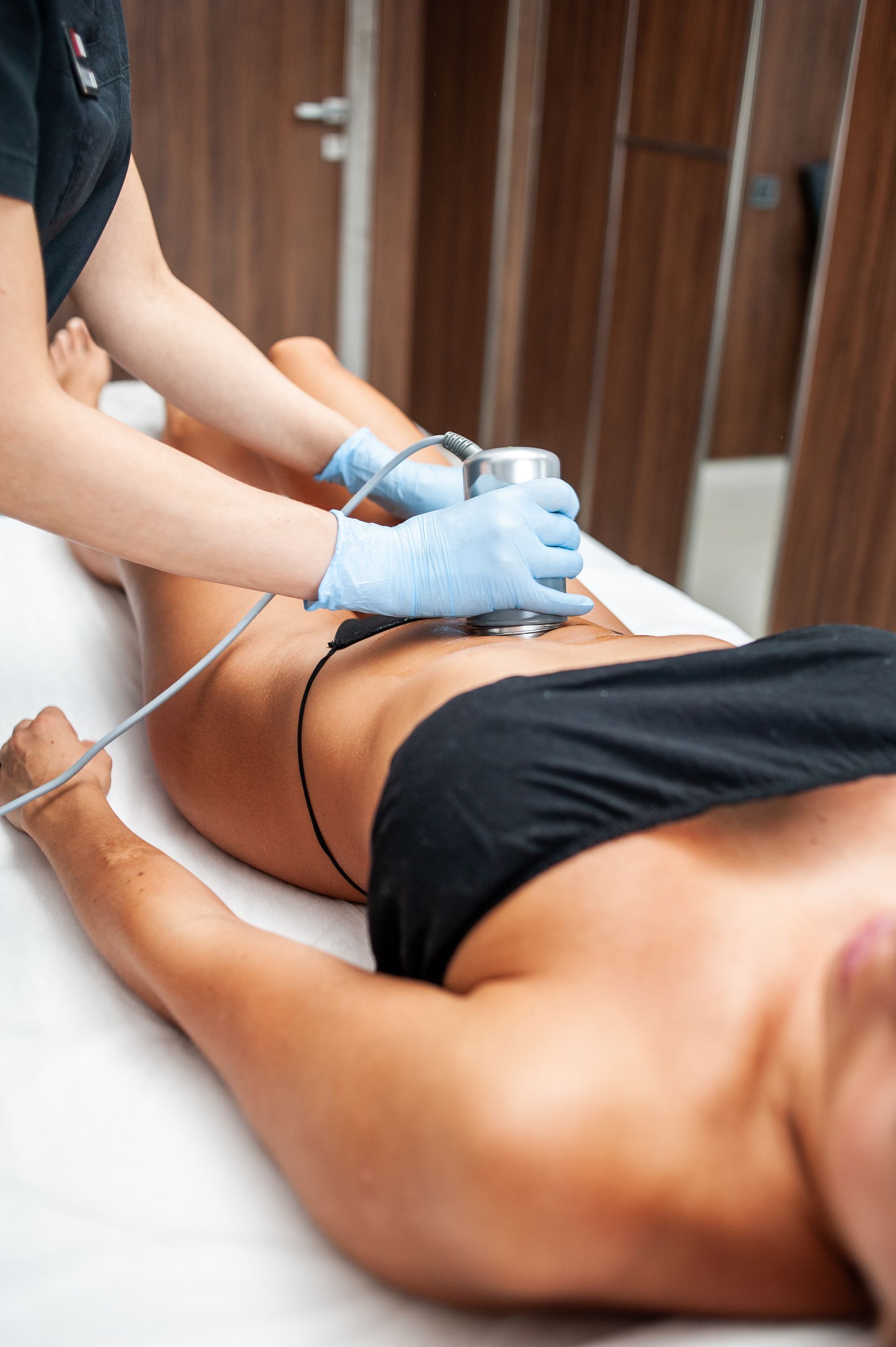 A woman is getting a massage on her stomach in a spa.