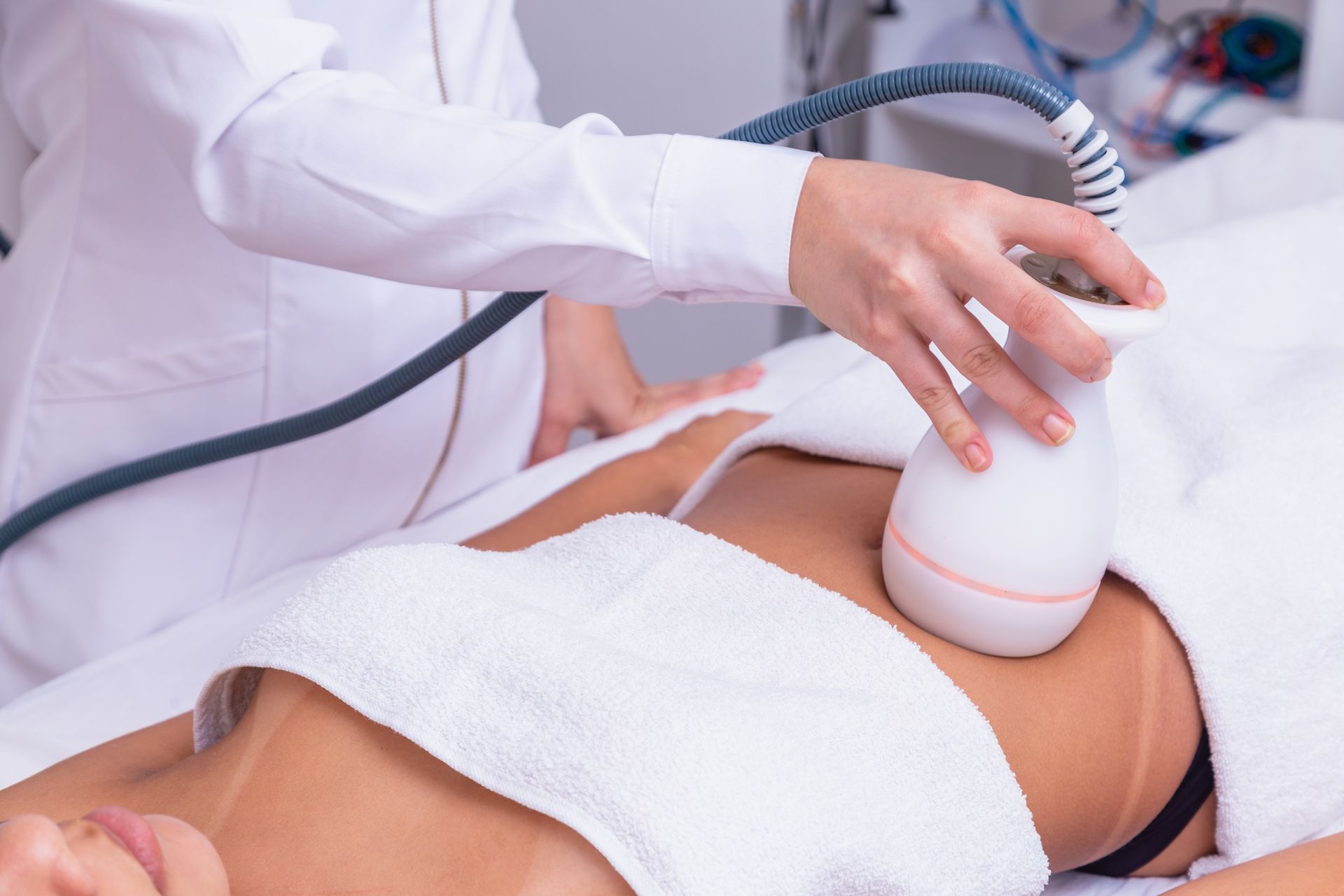 A woman is getting an ultrasound treatment on her stomach.