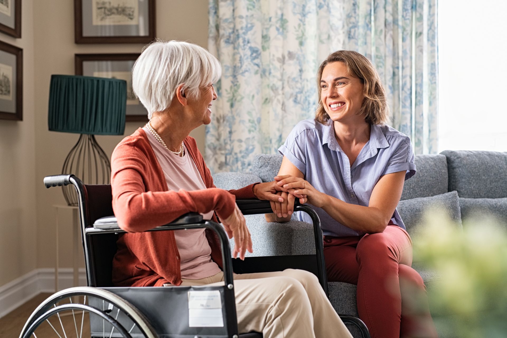 An in-home care nurse talking with her patient.