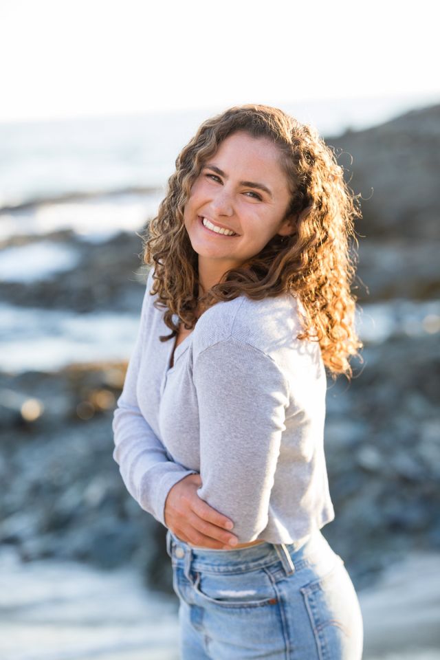 Senior girl in a sweater on the rocks, Laguna Beach