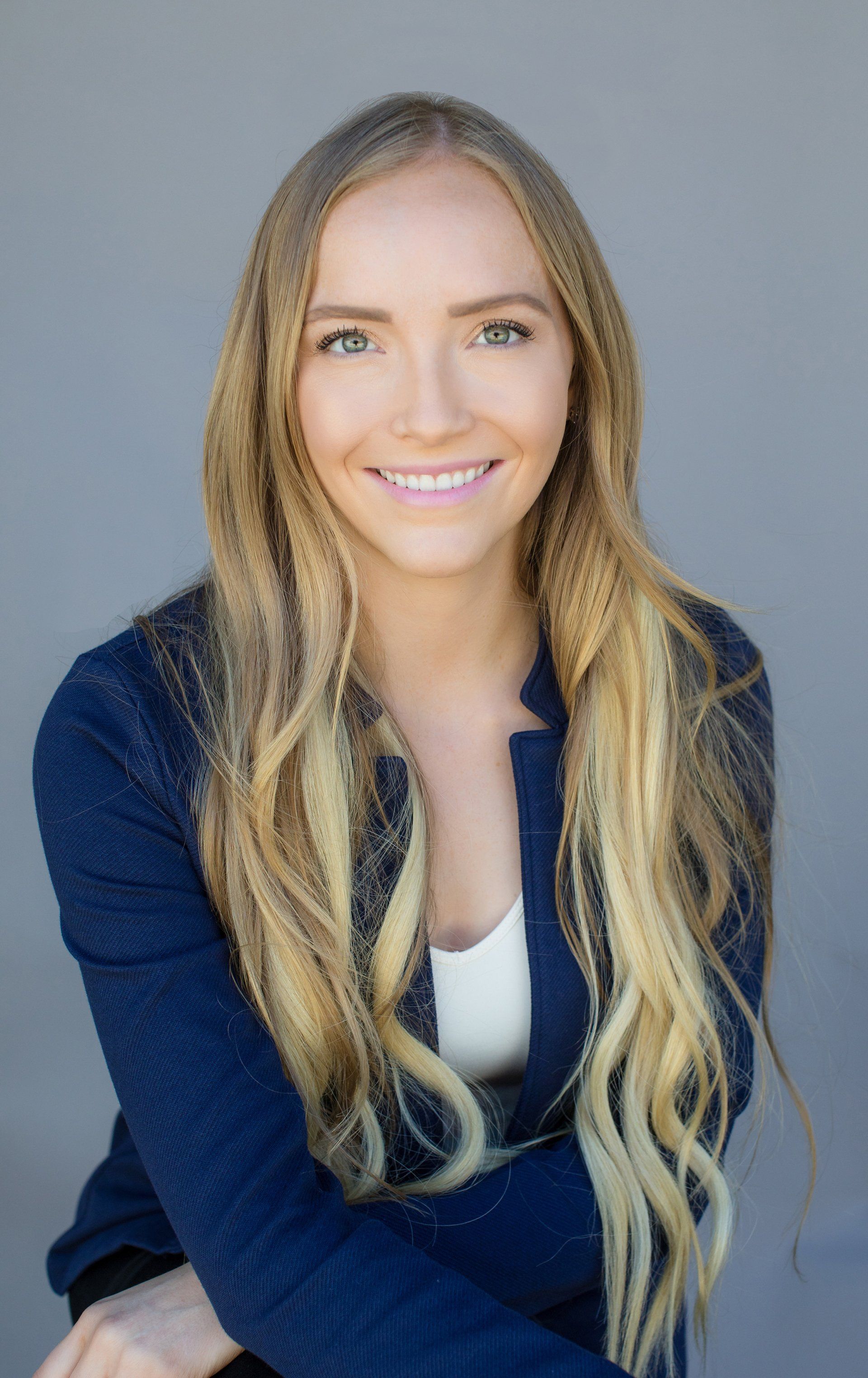 Commercial real estate headshot of an agent in a navy jacket