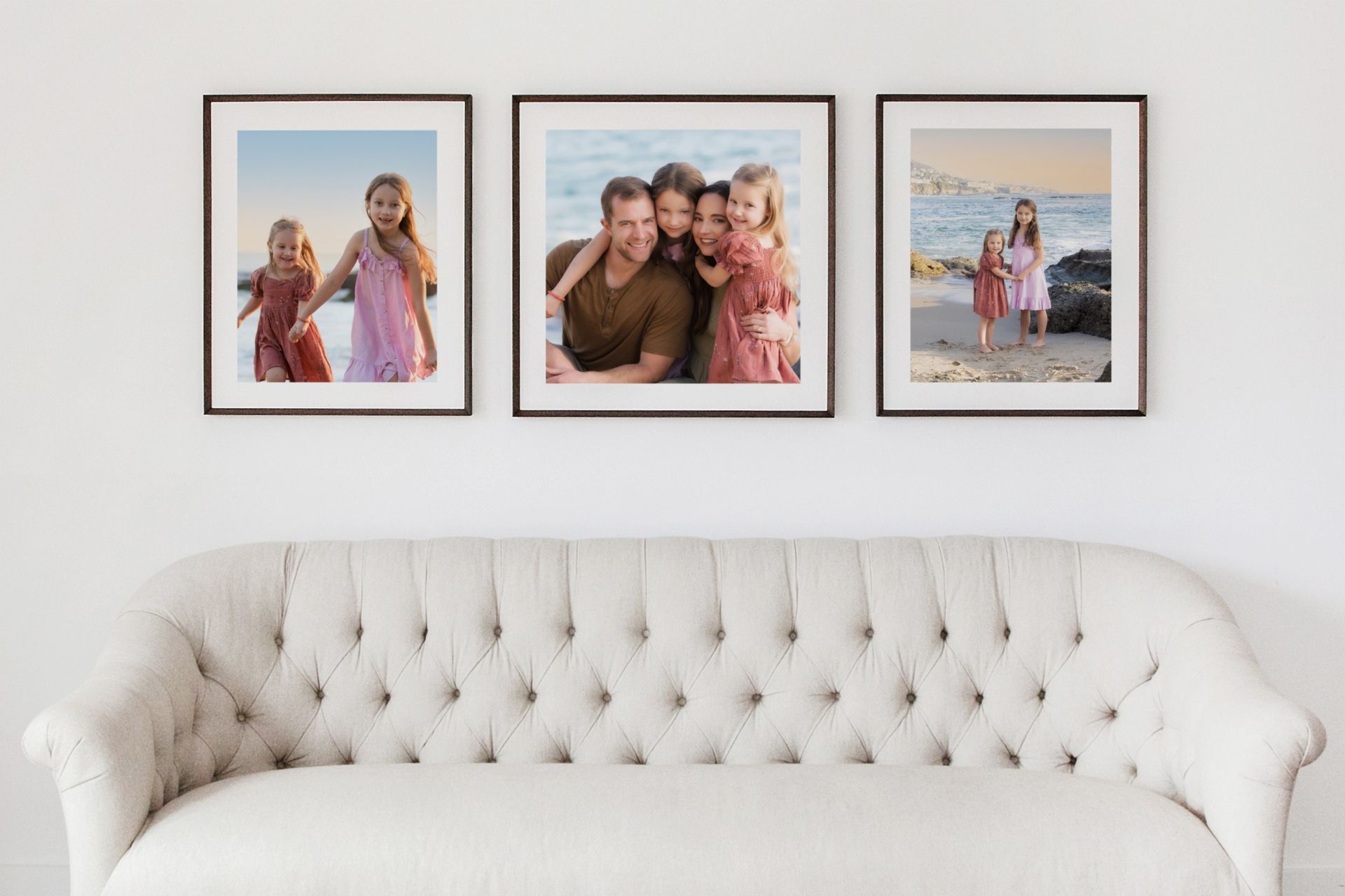 Framed family portraits displayed as wall art above a sofa in a styled living room