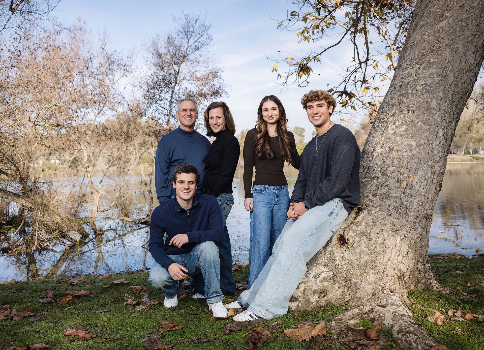 Family by a large sycamore tree at the lake in Huntington Beach Central Park