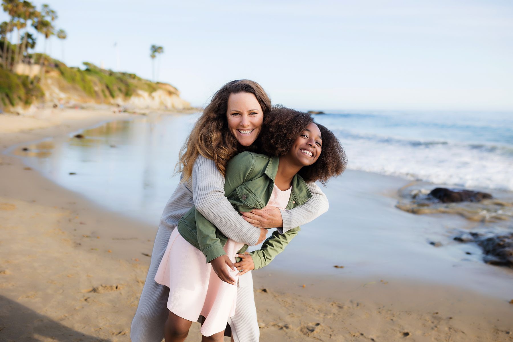 A mother with her child on the sand during a Laguna Beach family session