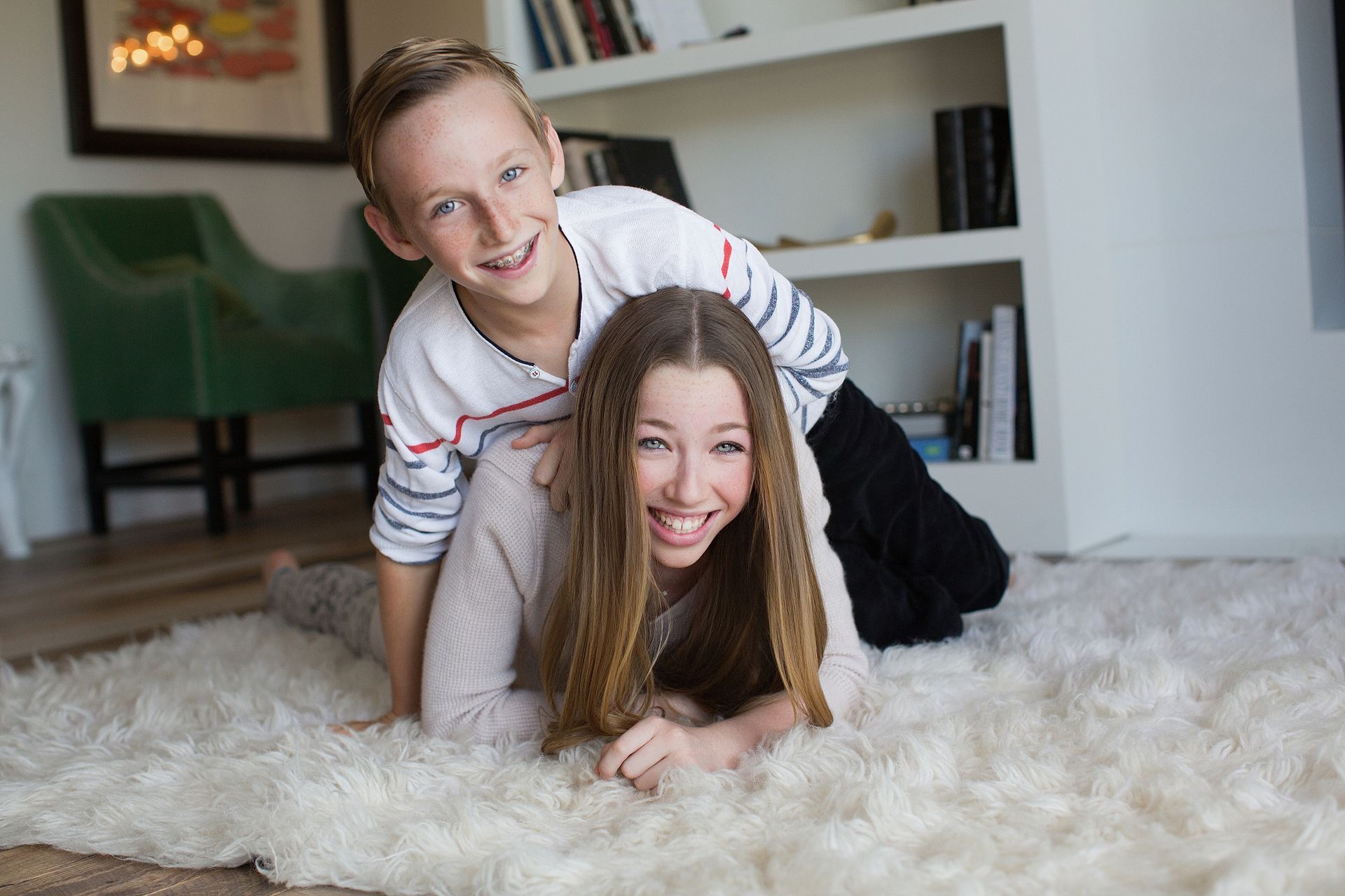 Sibling portrait Architectural Digest style family portrait showing home interior and natural posing.
