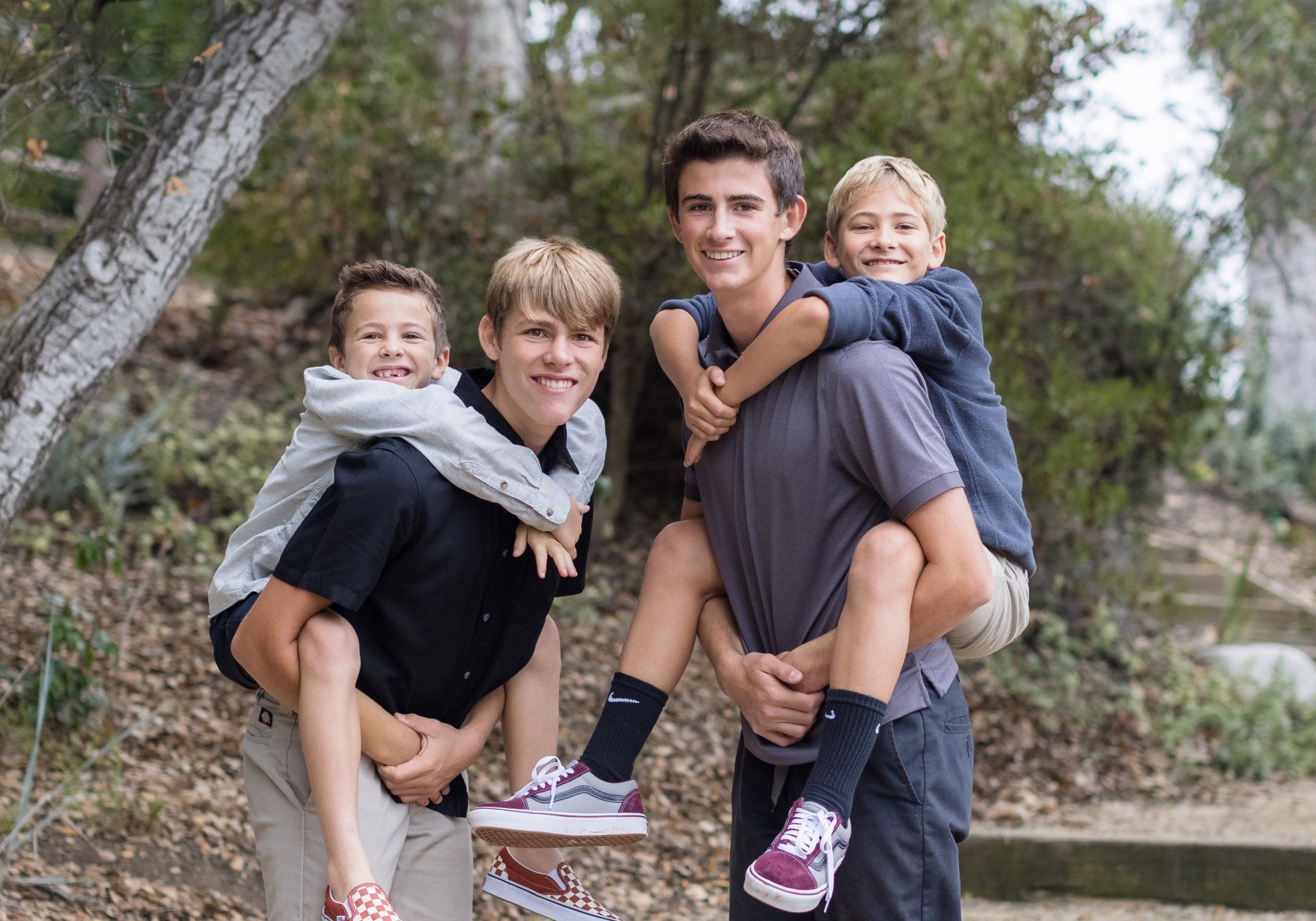 A man is carrying two children on his shoulders.