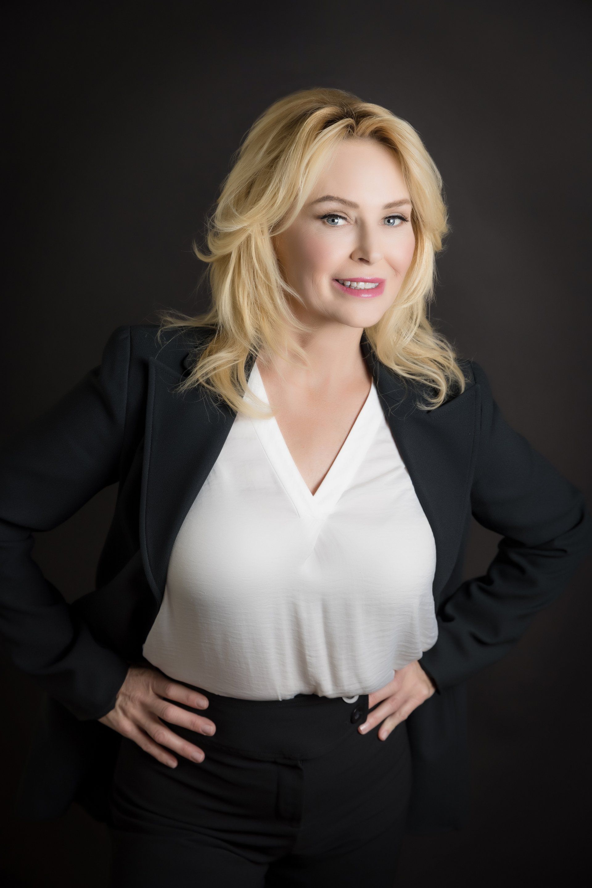Luxury real estate agent headshot on a dark backdrop