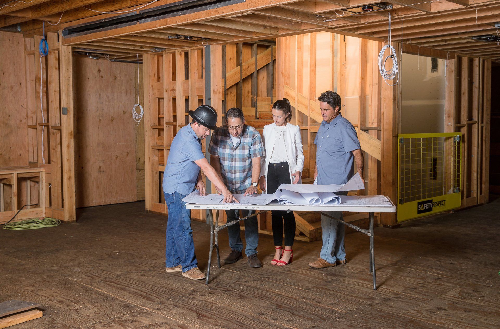 Real estate development team reviewing plans on a construction site