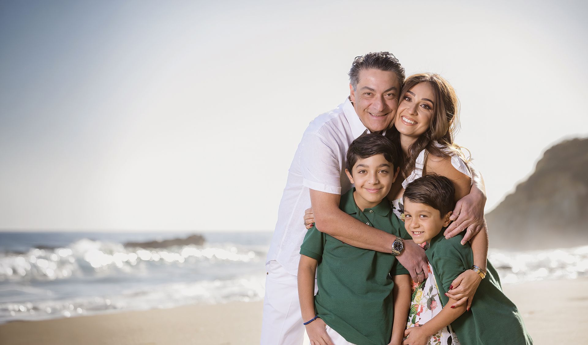 Family portrait on the rocks at a Laguna Beach cove