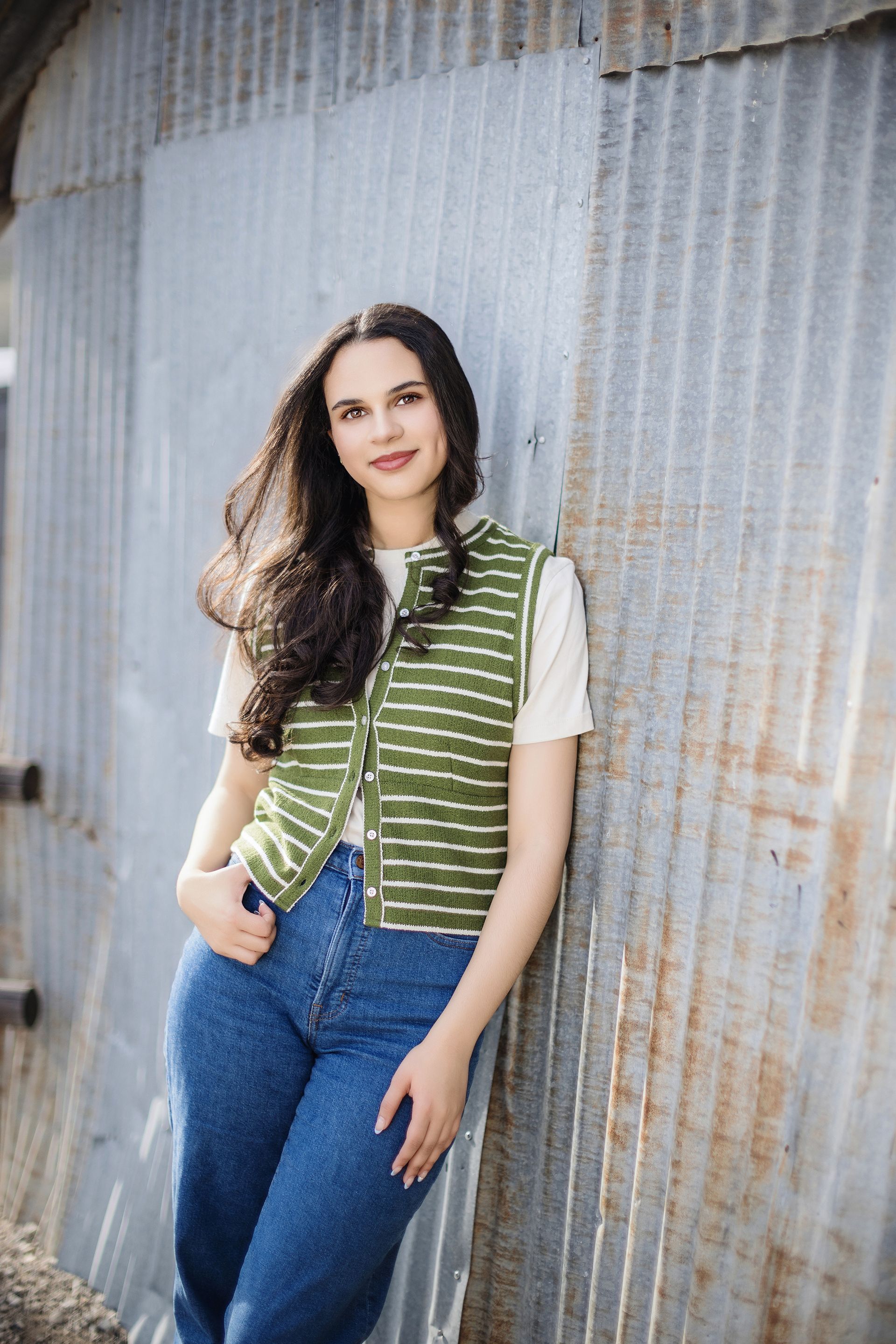 Outdoor high school senior portrait in Orange County, capturing golden hour light and a serene field backdrop