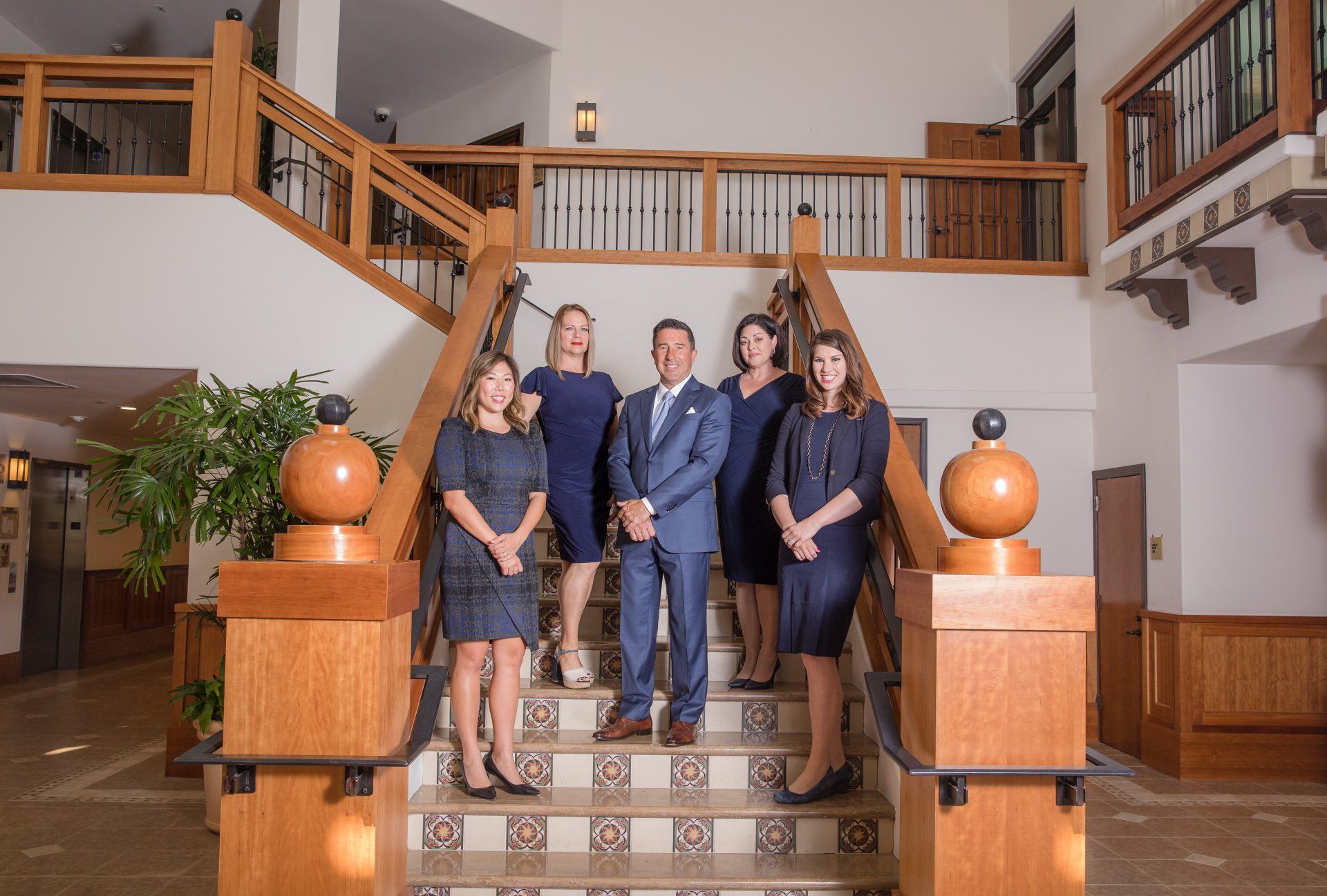 Wealth management team photo on an office staircase