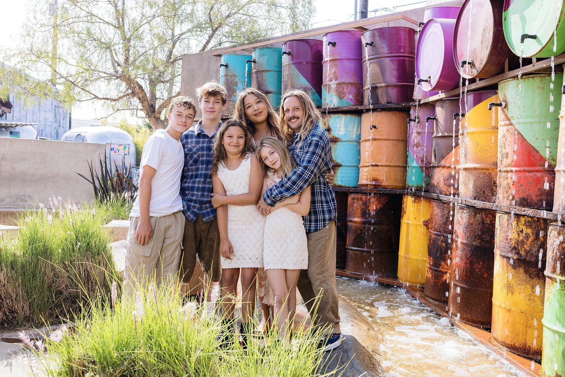 Family in front of the colorful barrel fountain at The LAB Anti-Mall in Costa Mesa