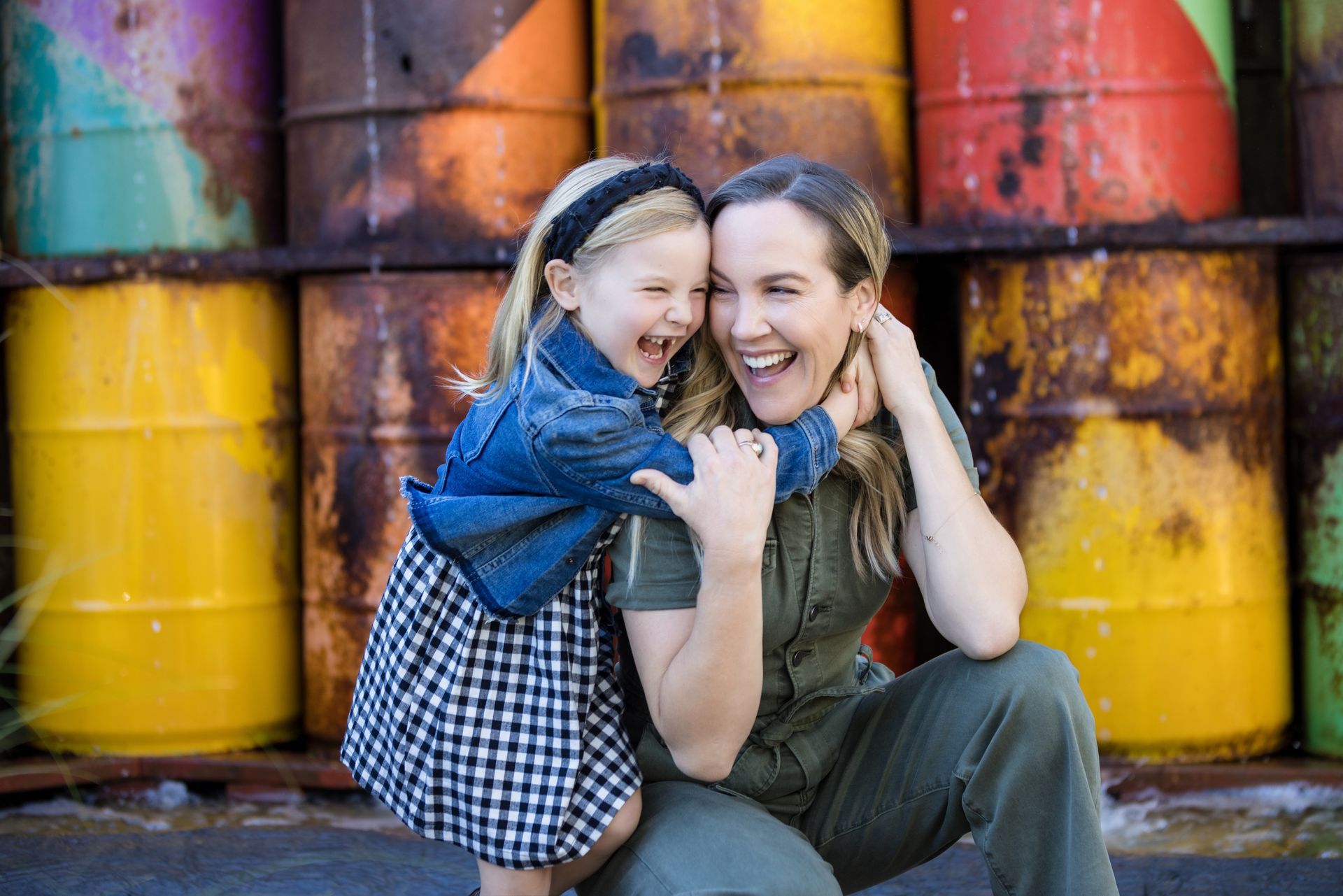 A young girl hugging her mom for a family photo at The Lab in Costa Mesa