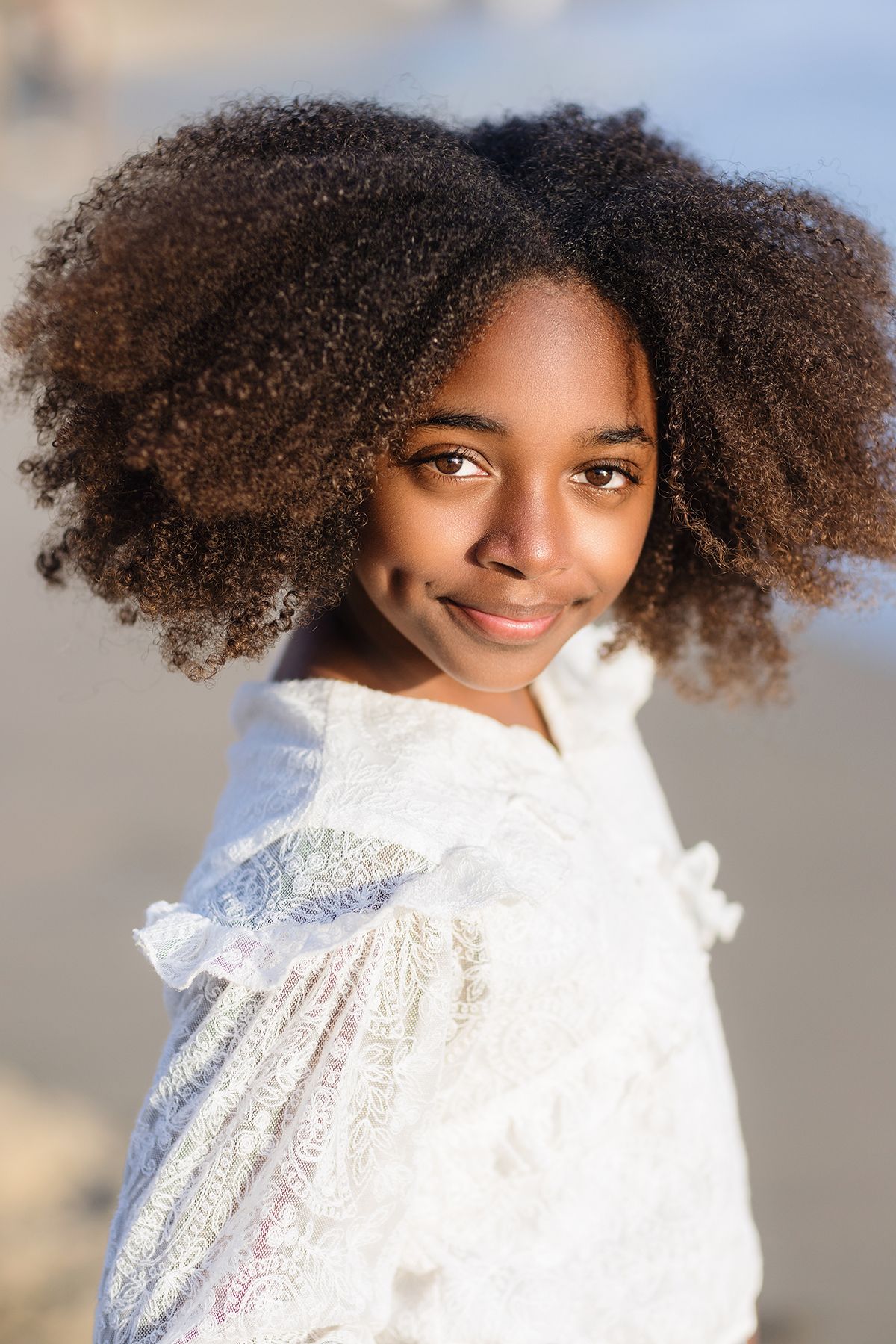 Close portrait of a young woman at golden hour on a Laguna Beach shoreline