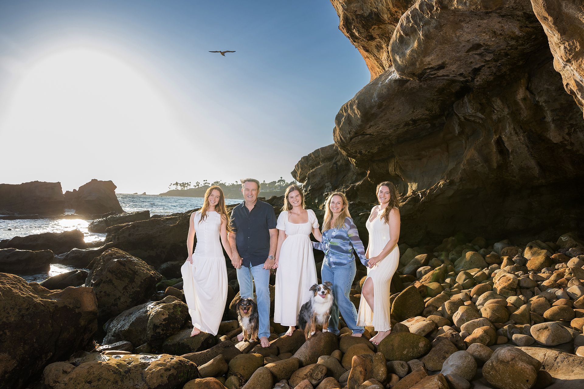 A family photographed with their dog on the beach in Laguna Beach