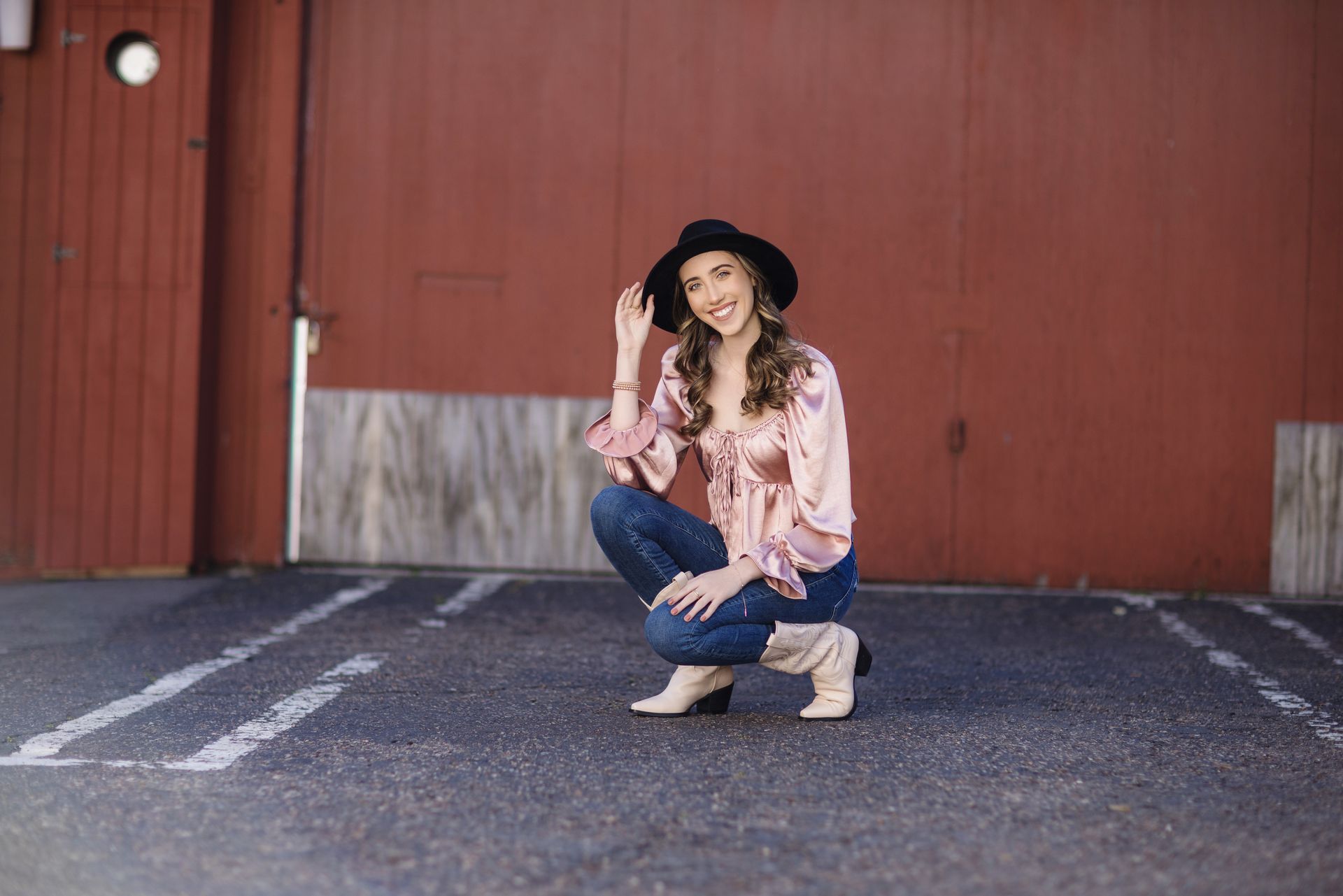 Teen photoshoot with girl again red wall with hot pink blouse.