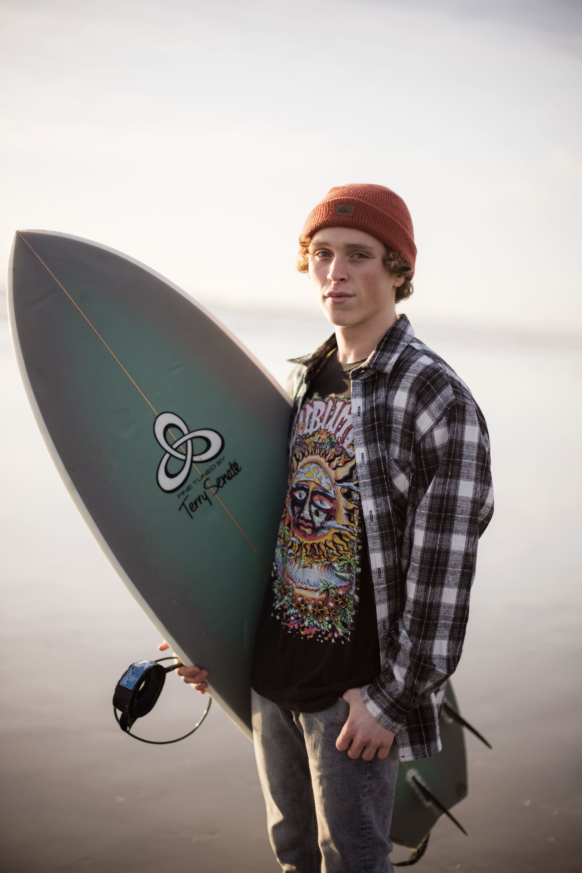 Senior guy holding a surfboard in Huntington Beach