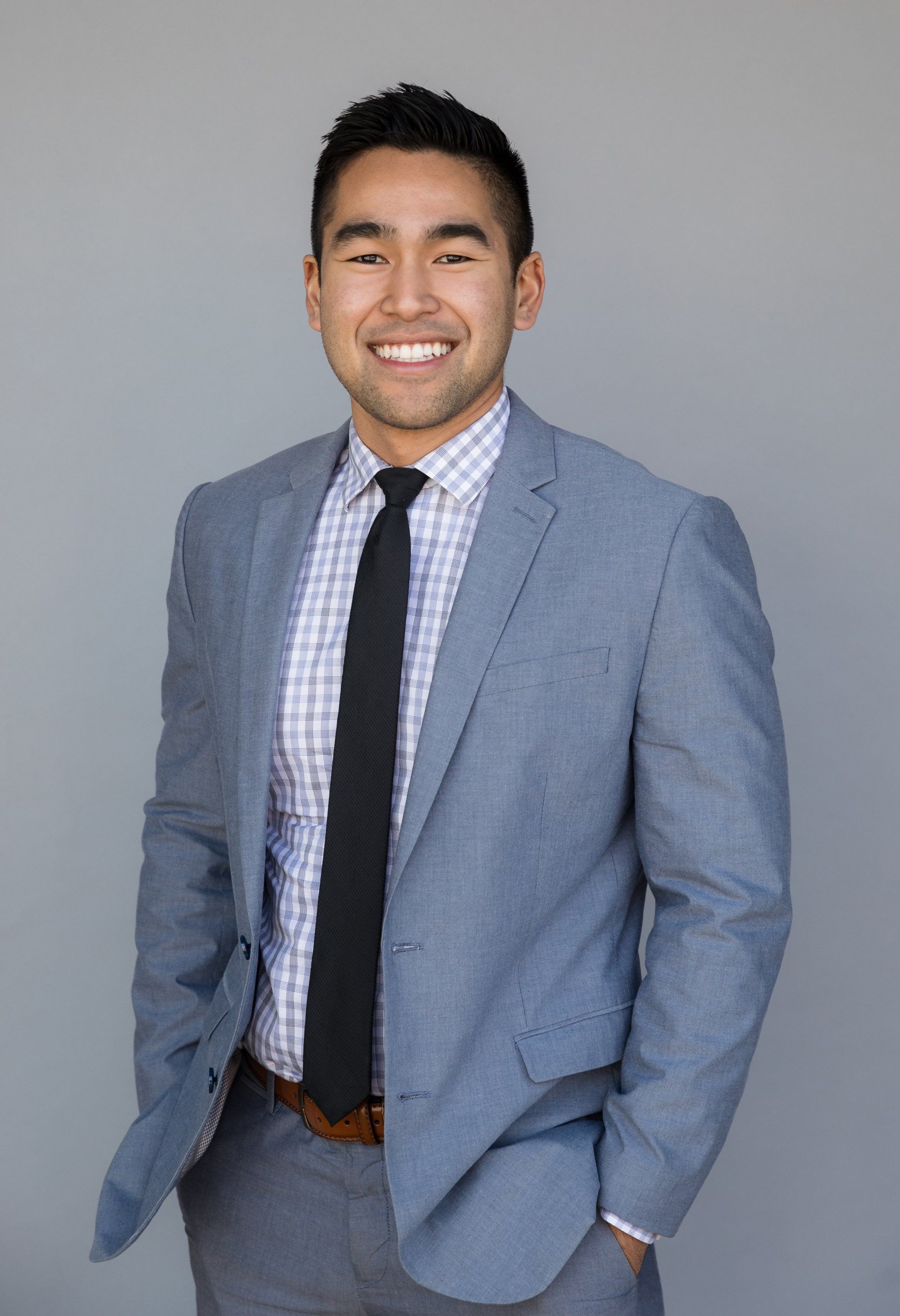 Realtor headshot of an agent in a light grey suit