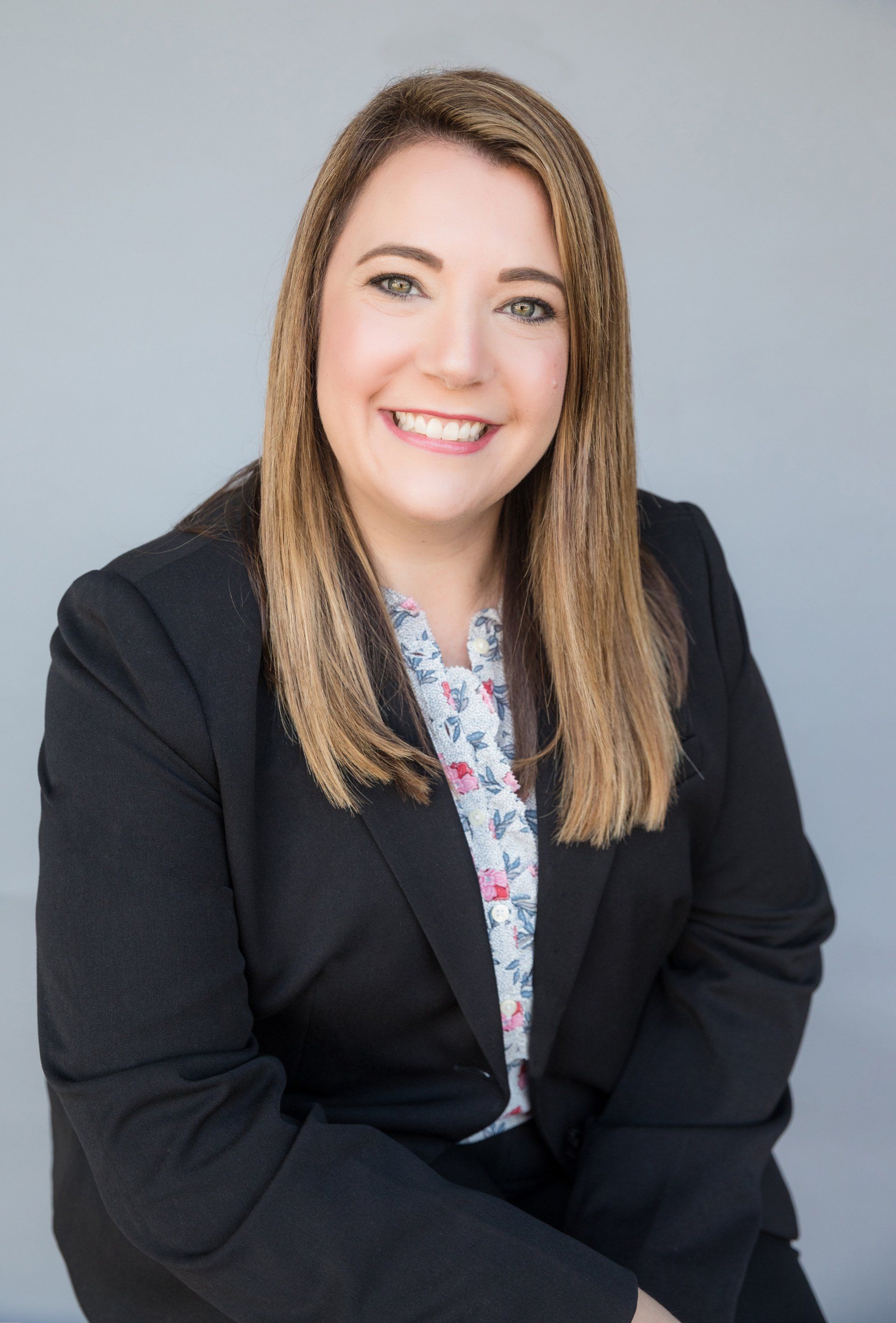Friendly realtor headshot of an agent in a black blazer