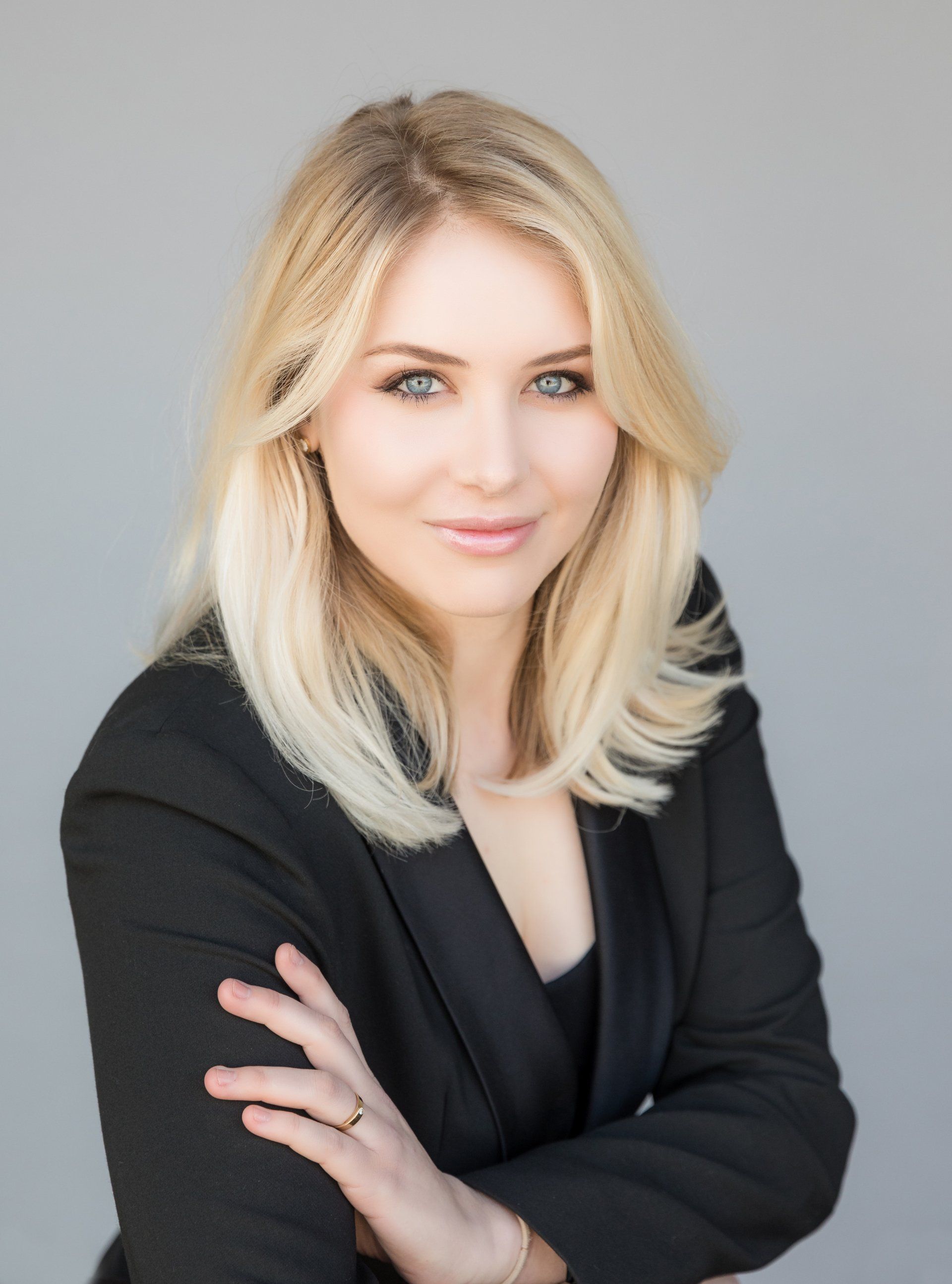 Realtor headshot of a blonde agent in a black blazer