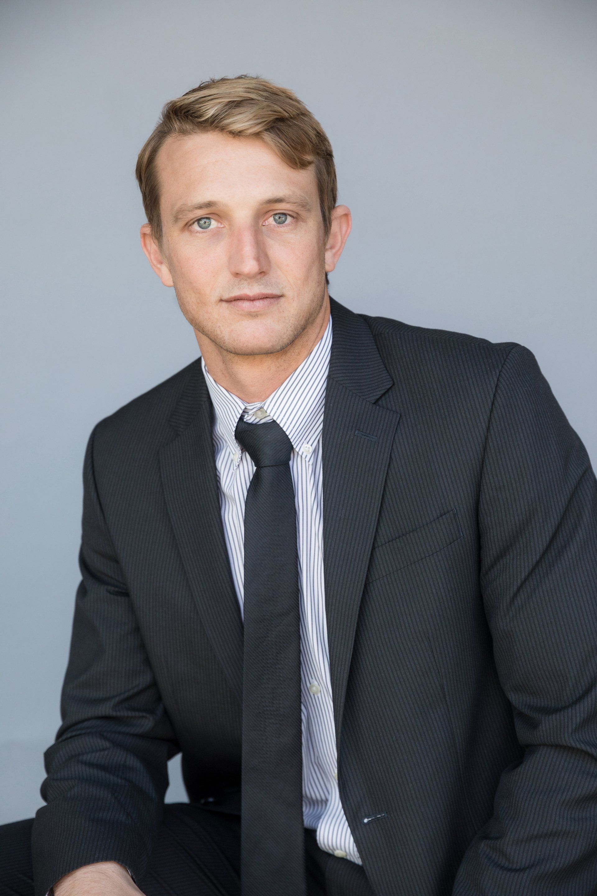 Real estate agent headshot in a dark suit and tie