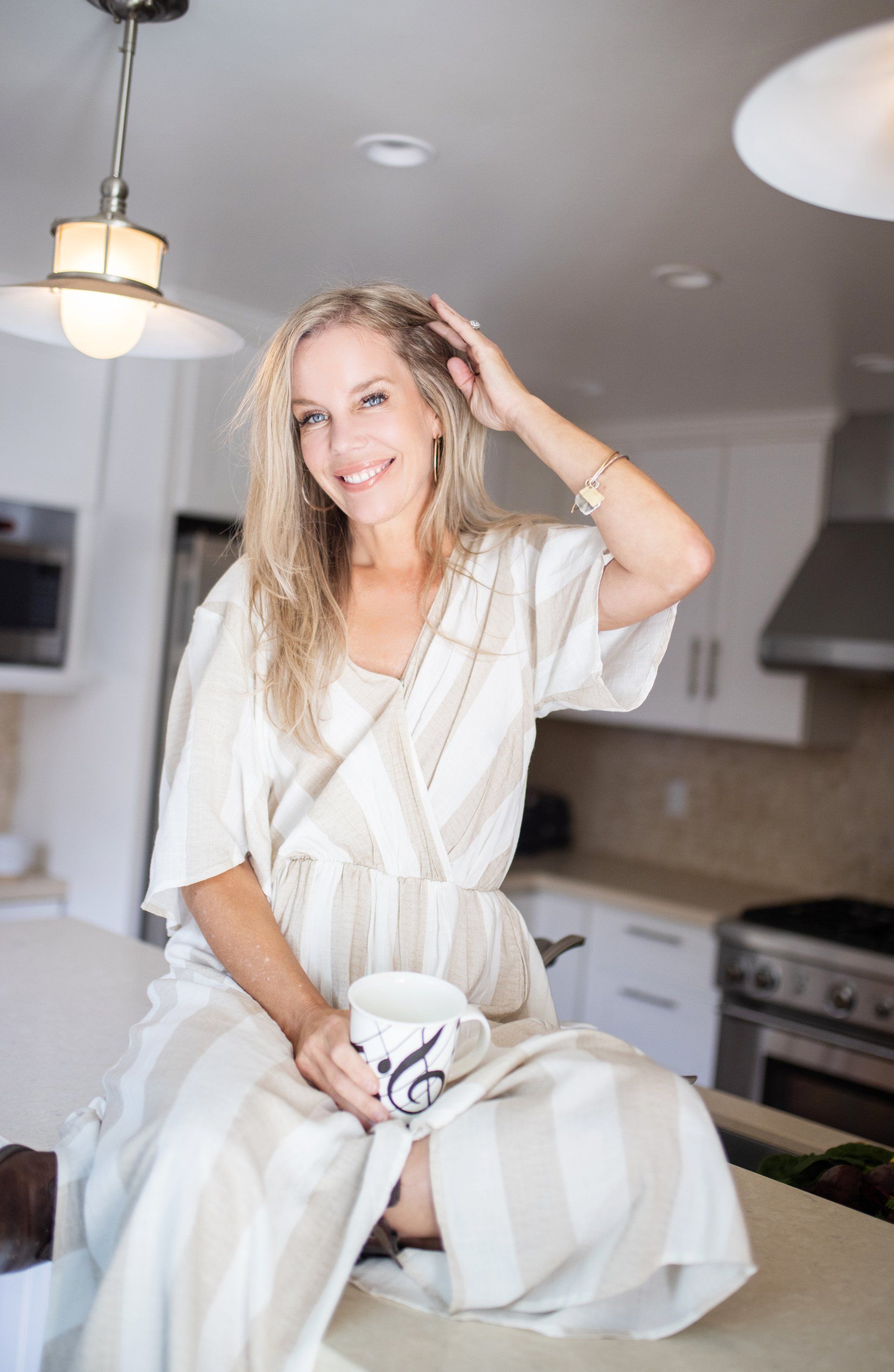 Health coach laughing at her kitchen counter