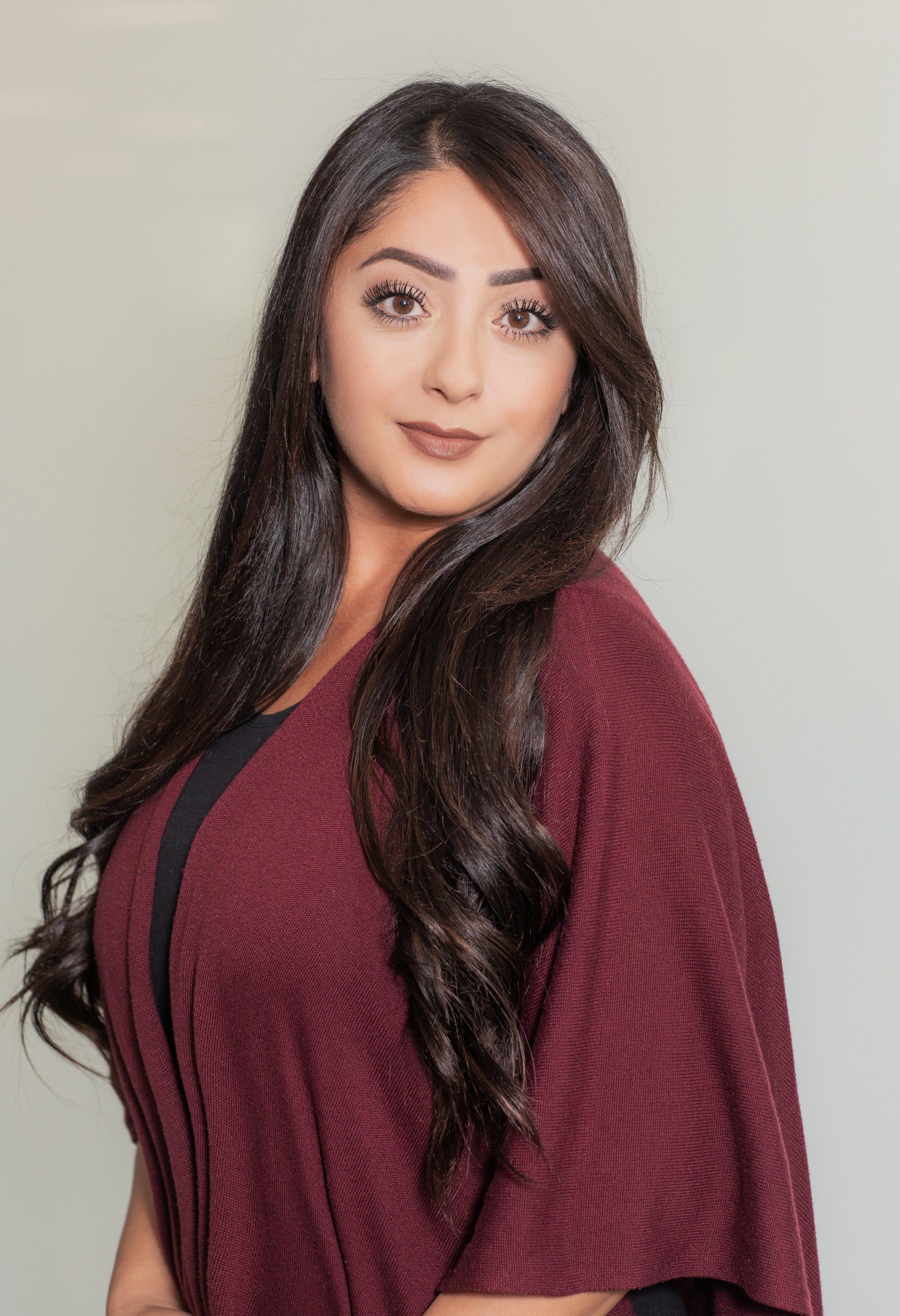 Financial professional headshot in a burgundy top