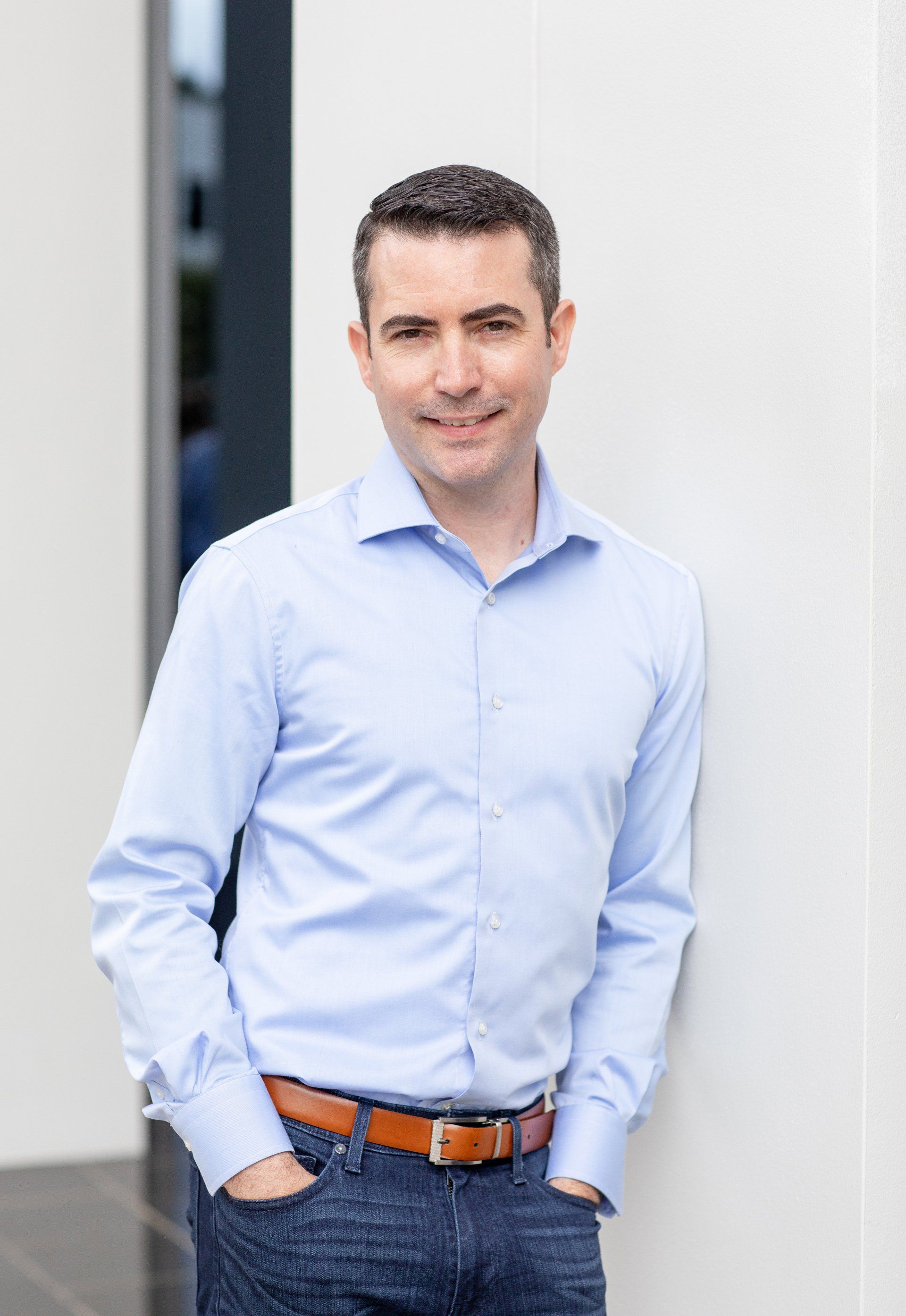 Approachable financial professional headshot in a light blue shirt